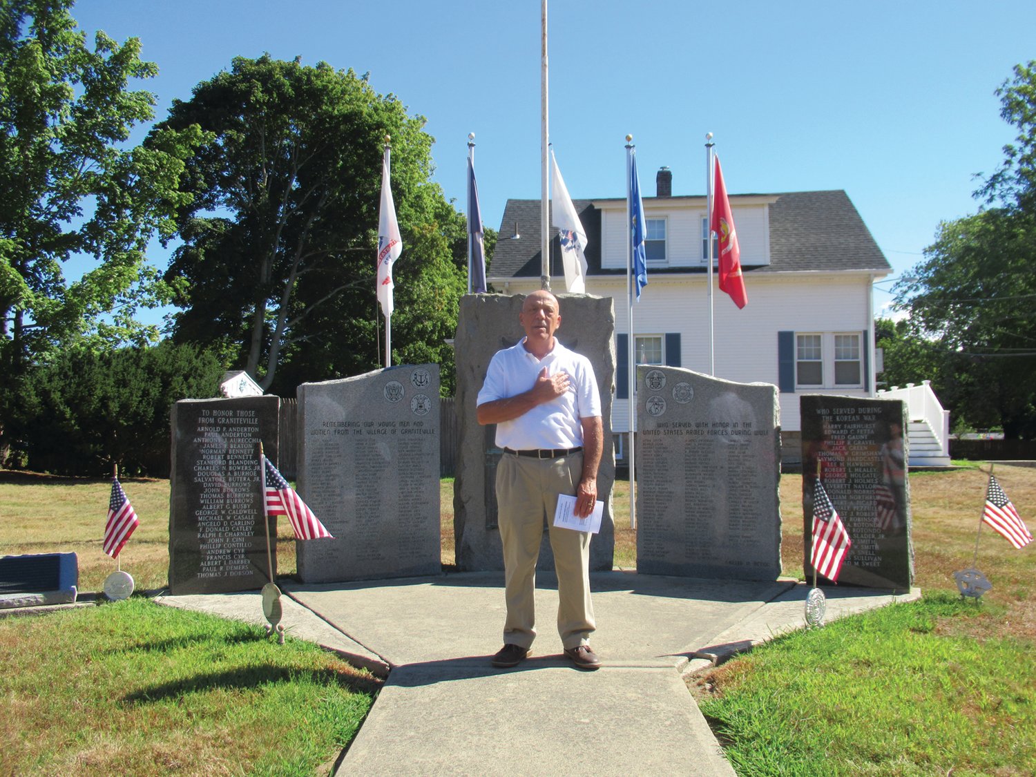 PROUD PLEDGE: Anthony Carlino, a long-time member of the Graniteville Veterans Foundations, leads the Pledge of Allegiance in front of the memorial off Putnam Pike in Johnston.